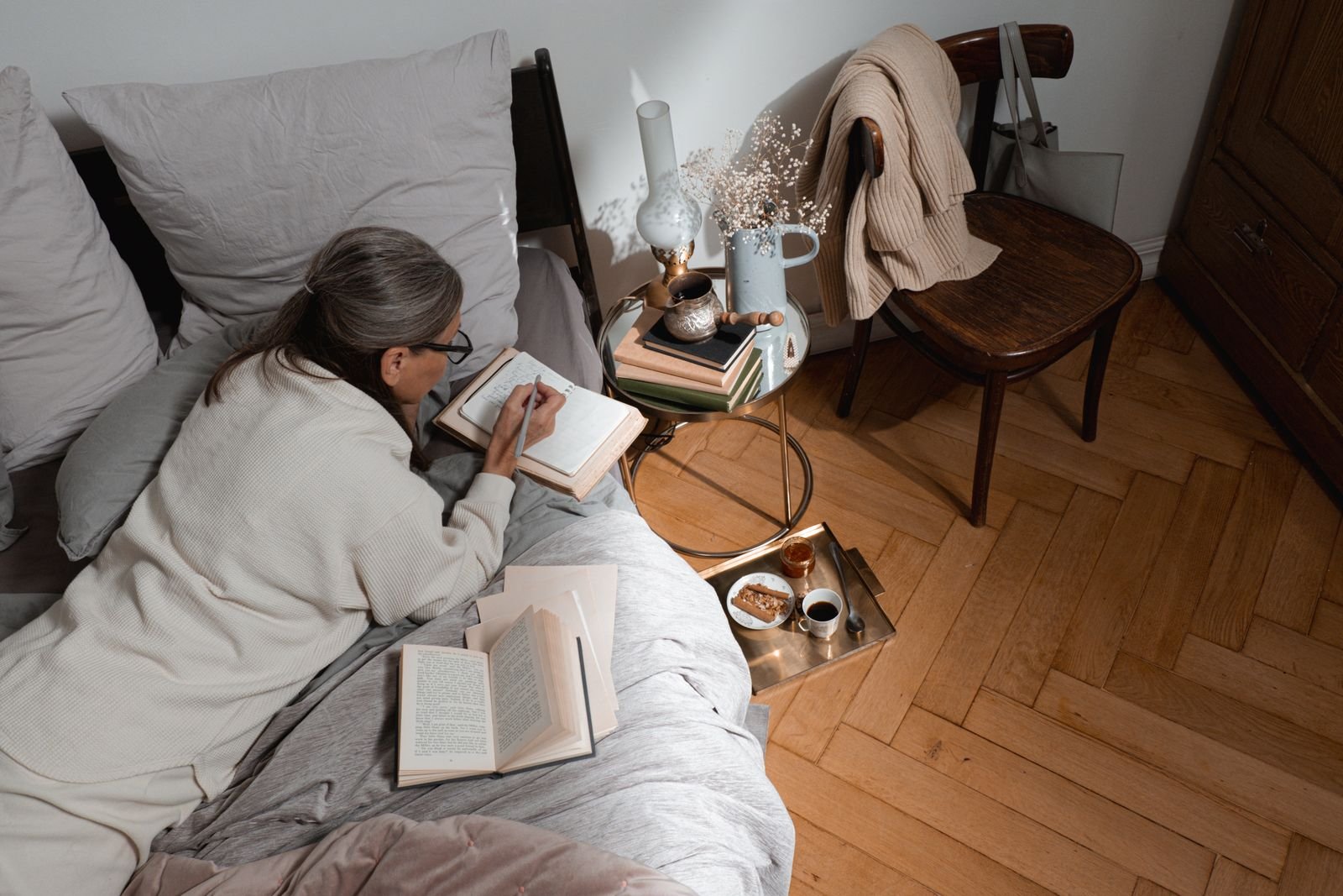 A person journaling with a warm drink nearby